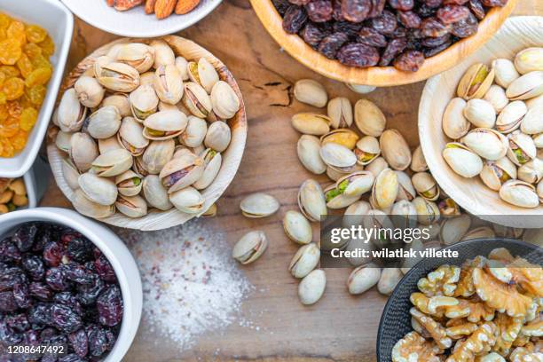 many nuts healthy fat and protein food and snack, ketogenic diet food - handvol stockfoto's en -beelden