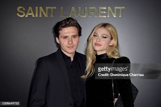 Brooklyn Beckham and Nicola Peltz attends the Saint Laurent show as part of the Paris Fashion Week Womenswear Fall/Winter 2020/2021 on February 25,...