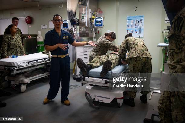 In this handout released by the U.S. Navy, Lt. J.g. Jan Sangrones leads medical response team training aboard the hospital ship USNS Comfort as the...