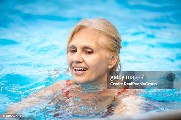 senior woman enjoying summer vacation - aqua fitness stock pictures, royalty-free photos & images