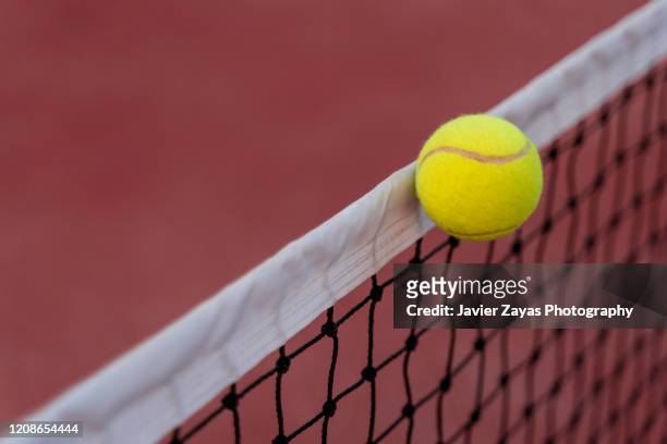 tennis ball hitting the net - missed train stockfoto's en -beelden