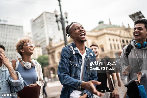 group of friends talking and dancing in the street - singing group stock pictures, royalty-free photos & images