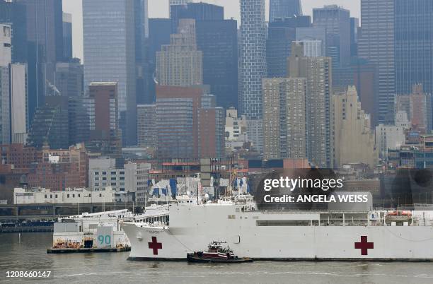 The USNS Comfort medical ship moves up the Hudson River as it arrives on March 30, 2020 in New York as seen from Weehawken, New Jersey. A military...