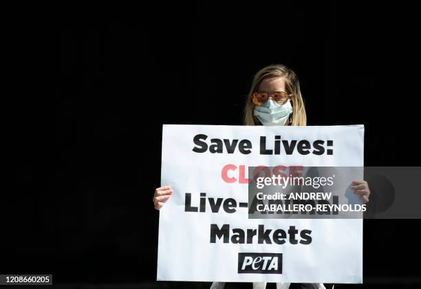 Members of PETA protest live markets outside the World Health Organization in Washington, DC on March 30, 2020. - The novel coronavirus, which has...