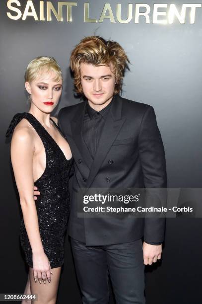 Maika Monroe and Joe Keery attend the Saint Laurent show as part of the Paris Fashion Week Womenswear Fall/Winter 2020/2021 on February 25, 2020 in...