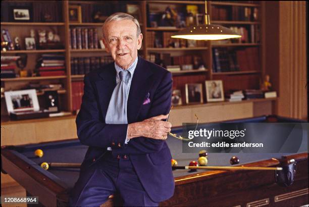 Fred Astaire, American dancer, singer, actor, choreographer, and television presenter in the living room of his home in Beverly Hills, California in...