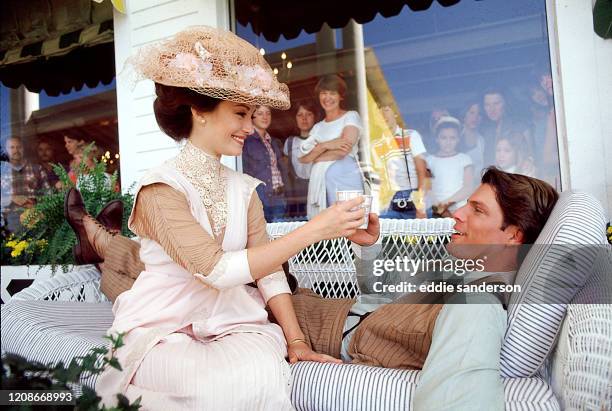 Actress Jane Seymour and Actor Christopher Reeve take a break during filming of 'Somewhere in Time' on the veranda of the Grand Hotel in Mackinac...