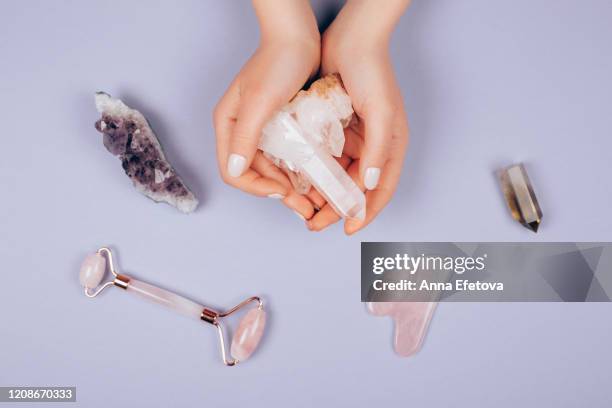 massagers in woman's hands - jade stock pictures, royalty-free photos & images