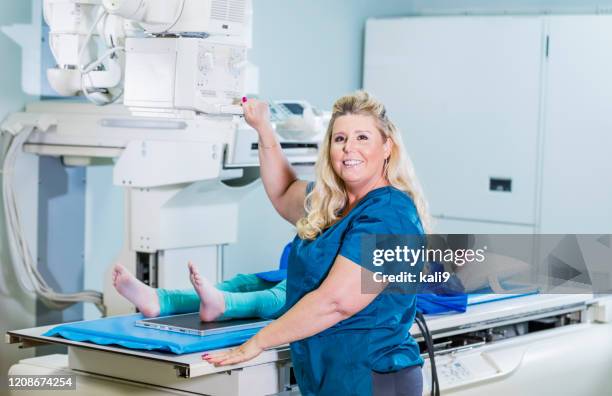 technologist taking x-ray of girl's foot - radiographer stock pictures, royalty-free photos & images