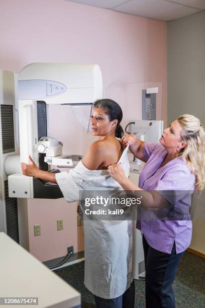 african-american woman getting a mammogram - mammogram diversity stock pictures, royalty-free photos & images