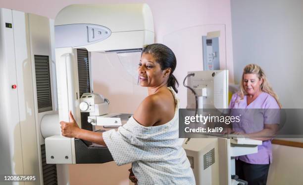 african-american woman getting a mammogram - mammogram diversity stock pictures, royalty-free photos & images