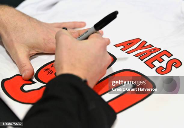 Dave Ayres signs autographs for fans during the game between the Dallas Stars and Carolina Hurricanes at at PNC Arena on February 25, 2020 in...