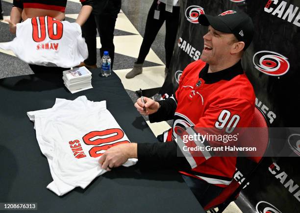 Dave Ayres signs autographs for fans during the game between the Dallas Stars and Carolina Hurricanes at at PNC Arena on February 25, 2020 in...