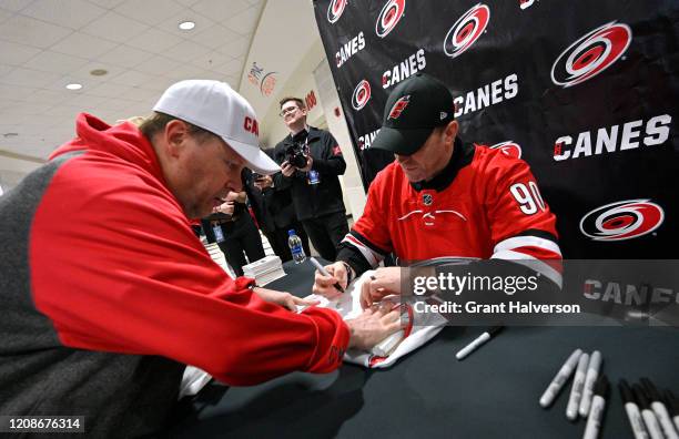 Dave Ayres signs autographs for fans during the game between the Dallas Stars and Carolina Hurricanes at at PNC Arena on February 25, 2020 in...