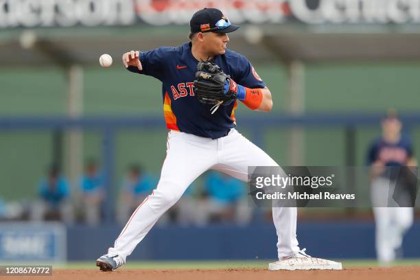 Aledmys Diaz of the Houston Astros drops the ball as he attempts to turn a double play in the fourth inning against the Miami Marlins during a...
