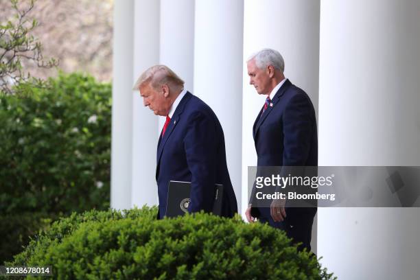 President Donald Trump and U.S. Vice President Mike Pence, right, arrive for a Coronavirus Task Force news conference in the Rose Garden of the White...