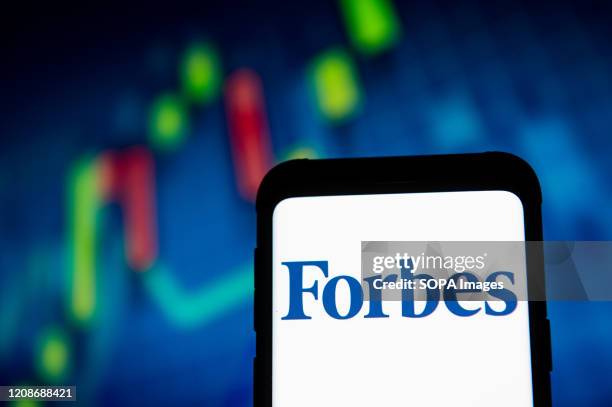 In this photo illustration a Forbes logo seen displayed on a smartphone.