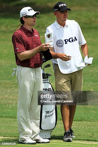 Marty Jertson waits with his caddie during the first round of the 93rd PGA Championship at the Atlanta Athletic Club on August 11, 2011 in Johns...