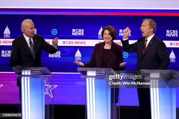 Democratic presidential candidates former Vice President Joe Biden and Tom Steyer debate as Sen. Amy Klobuchar reacts during the Democratic...