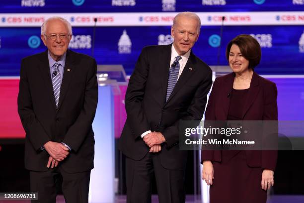 Democratic presidential candidates Sen. Bernie Sanders , former Vice President Joe Biden, and Sen. Amy Klobuchar walk on stage before the Democratic...