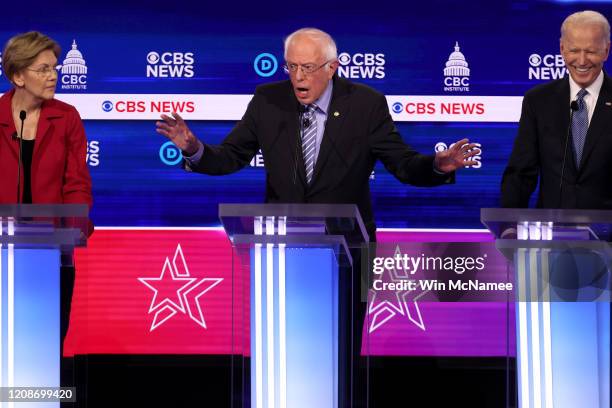 Democratic presidential candidates Sen. Bernie Sanders speaks as Sen. Elizabeth Warren and former Vice President Joe Biden react during the...