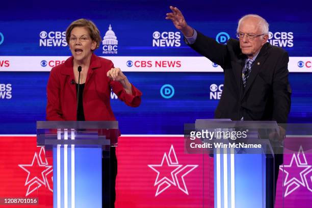 Democratic presidential candidate Sen. Elizabeth Warren speaks as Sen. Bernie Sanders looks on during the Democratic presidential primary debate at...