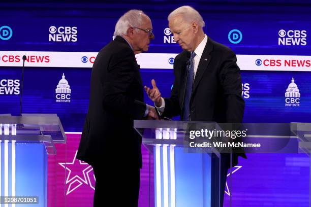 Democratic presidential candidates Sen. Bernie Sanders and former Vice President Joe Biden speak during a break at the Democratic presidential...