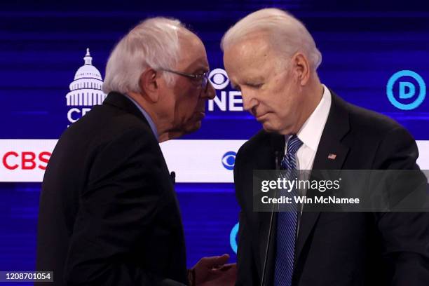 Democratic presidential candidates Sen. Bernie Sanders and former Vice President Joe Biden speak during a break at the Democratic presidential...