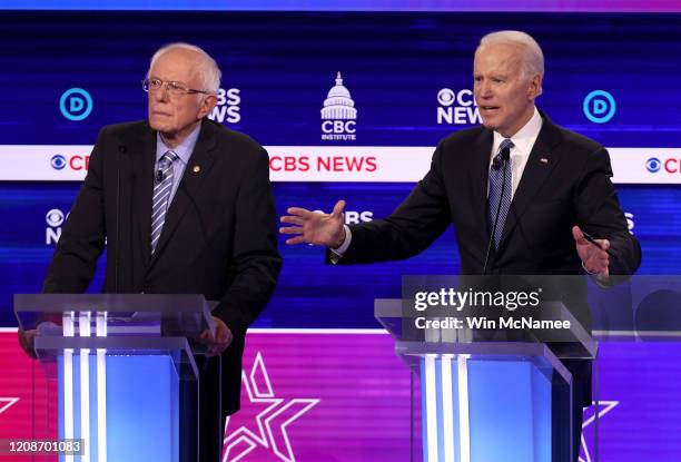 Democratic presidential candidate former Vice President Joe Biden speaks as Sen. Bernie Sanders looks on during the Democratic presidential primary...