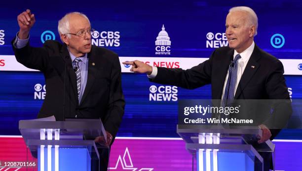 Democratic presidential candidate former Vice President Joe Biden speaks as Sen. Bernie Sanders looks on during the Democratic presidential primary...