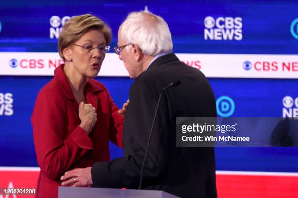 Democratic presidential candidates Sen. Elizabeth Warren and Sen. Bernie Sanders interact during a break at the Democratic presidential primary...