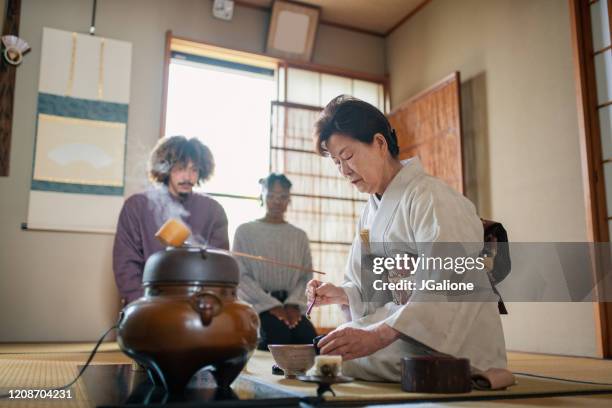 japanese tea master performing a traditional japanese tea ceremony - people showing respect stock pictures, royalty-free photos & images