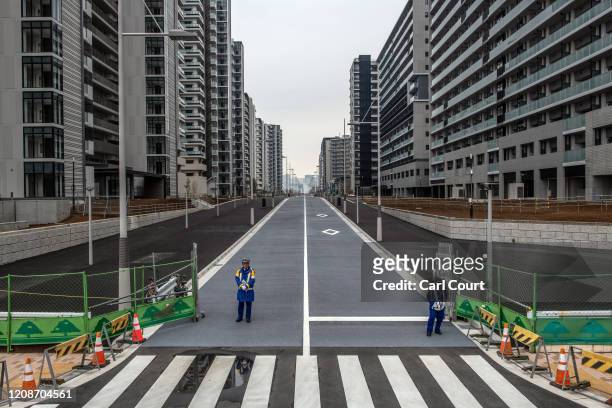 Security guards stand at an entrance to the Tokyo 2020 Olympics Athletes Village on March 31, 2020 in Tokyo, Japan. The Athletes Village, designed to...