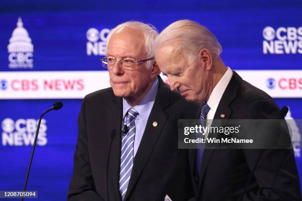 Democratic presidential candidates Sen. Bernie Sanders and former Vice President Joe Biden speak during a break at the Democratic presidential...