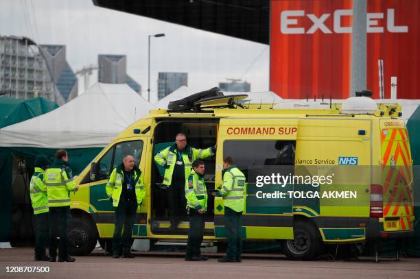 Staff stand by a London Ambulance Service Command Support vehicle parked outside the ExCeL London exhibition centre in London on March 31 where the...