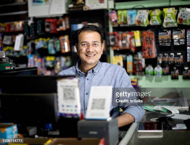 happy male cashier at supermarket - shop stock pictures, royalty-free photos & images