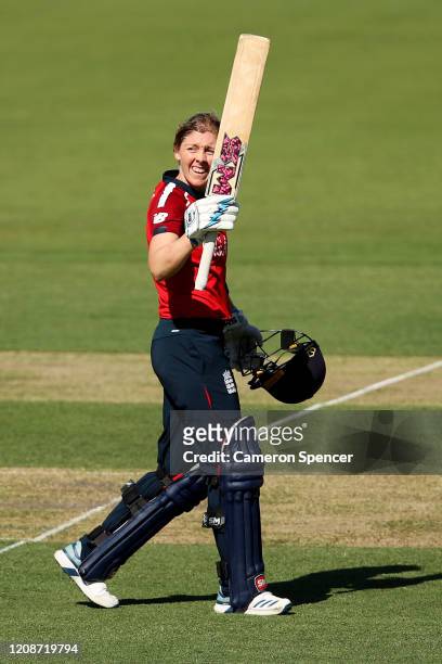 Heather Knight of England celebrates scoring a century during the ICC Women's T20 Cricket World Cup match between England and Thailand at Manuka Oval...