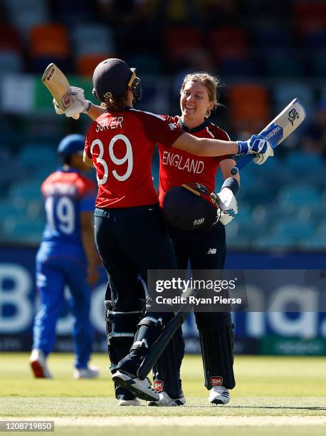 Heather Knight of England celebrates with Natalie Sciver of England after reaching her century during the ICC Women's T20 Cricket World Cup match...