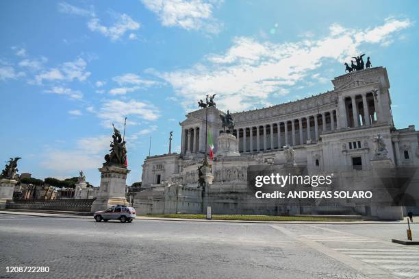 The Italian flag flies at half-mast on the Altare della Patria - Vittorio Emanuele II monument in Rome on March 31, 2020 as flags are being flown at...