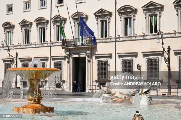 The Italian flag and the flag of Europe fly at half-mast on Palazzo Chigi government building in Rome on March 31, 2020 as flags are being flown at...