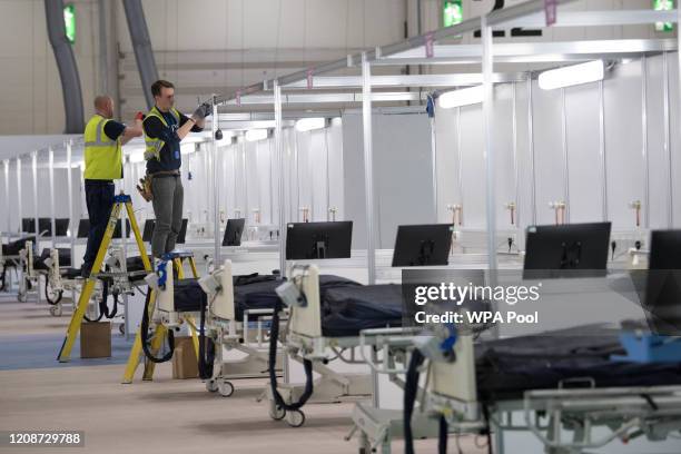 Work continues at the ExCel centre which is being made into the temporary NHS Nightingale hospital, comprising of two wards, each of 2,000 people, to...