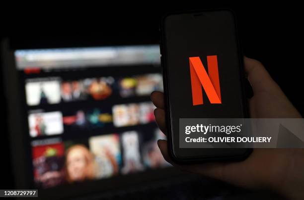 In this photo illustration a computer and a mobile phone screens display the Netflix logo on March 31, 2020 in Arlington, Virginia.