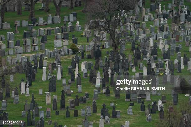 Headstones in Calvary Cemetery in the Borough of Queens on March 31, 2020 in New York. A military hospital ship arrived in New York on March 30, 2020...