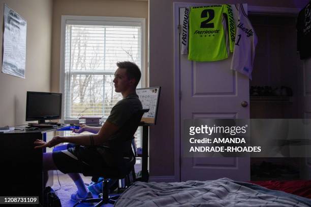 Liberty University student Jared Marshall, sits at his desk inside his apartment near Lynchburg, Virginia, on March 31, 2020. - Virginia's governor...