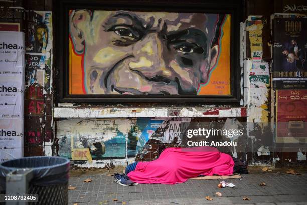 Homeless man sleeps on the empty streets in Montevideo on March 31, 2020.Since the first case of coronavirus was detected on March 13, the government...