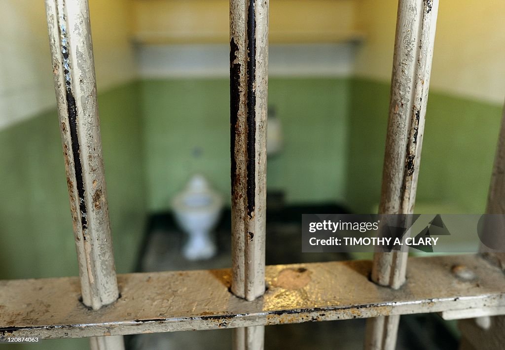 The worn bars in the cell block are seen
