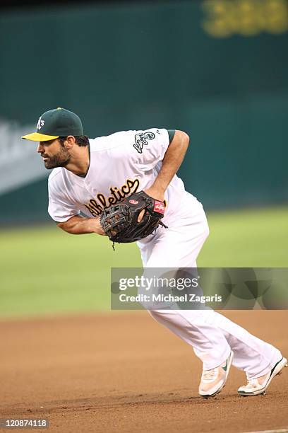 Conor Jackson of the Oakland Athletics fields during the game against the Tampa Bay Rays at the Oakland-Alameda County Coliseum on July 27, 2011 in...