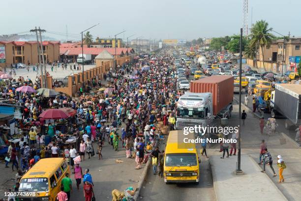 Lagos residents, despite social distancing order, cluster at Oke-Odo Market, Lagos Nigeria on Monday March 30, 2020 for last minute shopping. Federal...