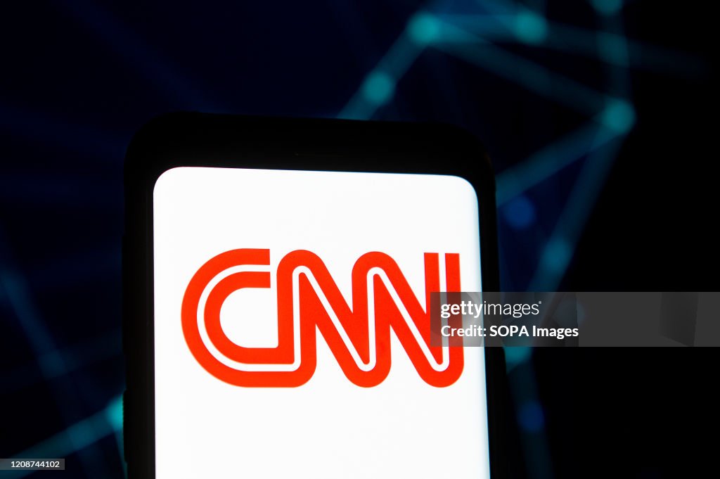In this photo illustration a CNN logo seen displayed on a...