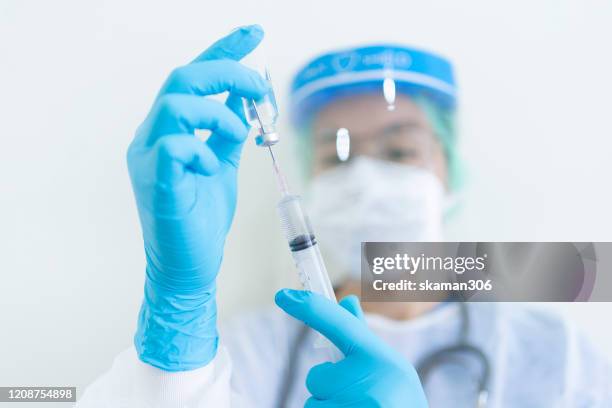 doctor wearing ppe (personal protection equipment ) or isolation grown suite for protect covid-19 (corona virus)and holding small airplane model and show stop flying - antibody testing stock pictures, royalty-free photos & images